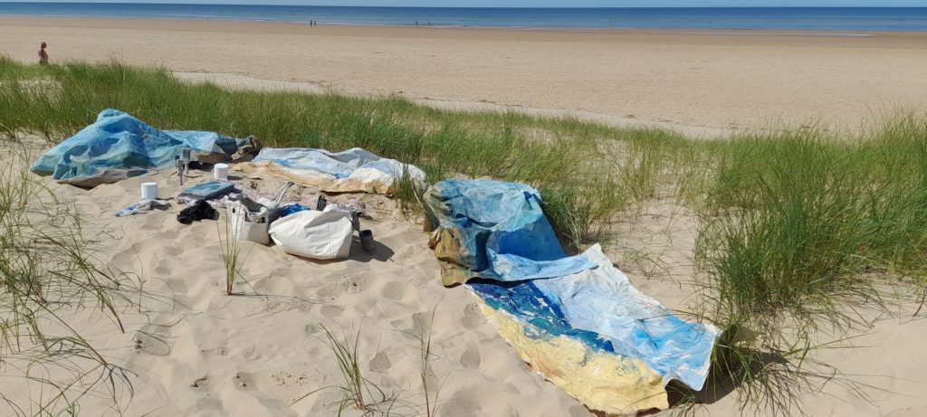 Mary Blue canvases on the beach